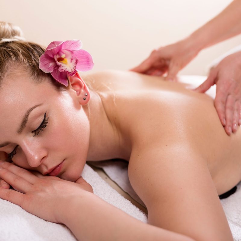 Woman lying in a beauty parlour, enjoying relaxing back massage